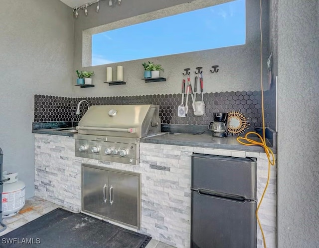 view of patio / terrace with a grill, area for grilling, and sink