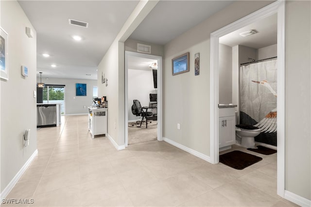 corridor featuring light tile patterned floors