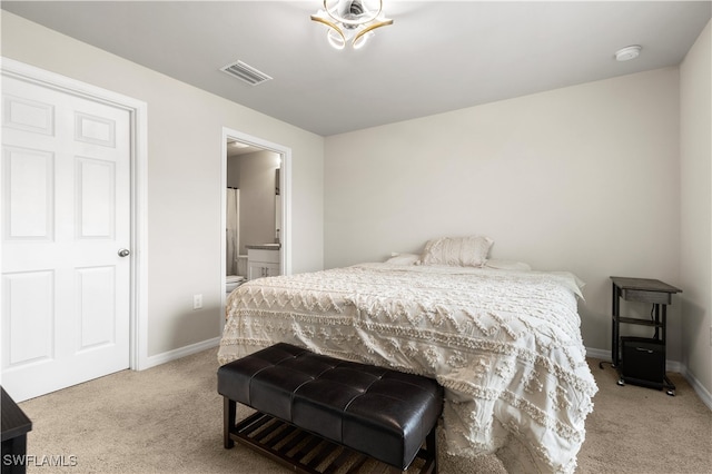 carpeted bedroom with ensuite bathroom