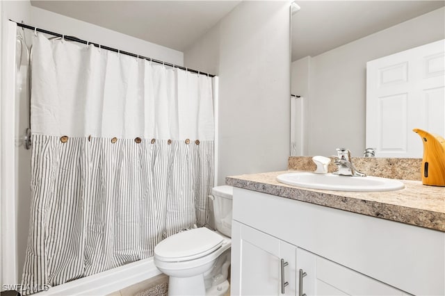 bathroom featuring vanity, toilet, and walk in shower