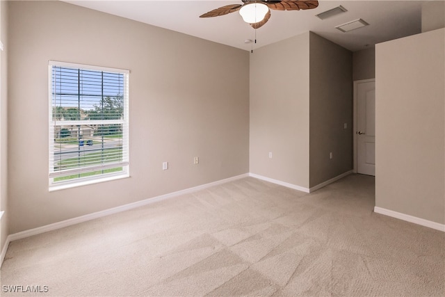 carpeted spare room with ceiling fan