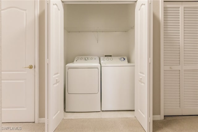 washroom with independent washer and dryer and light colored carpet