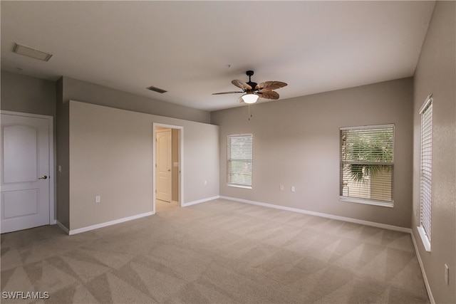 spare room with light colored carpet and ceiling fan