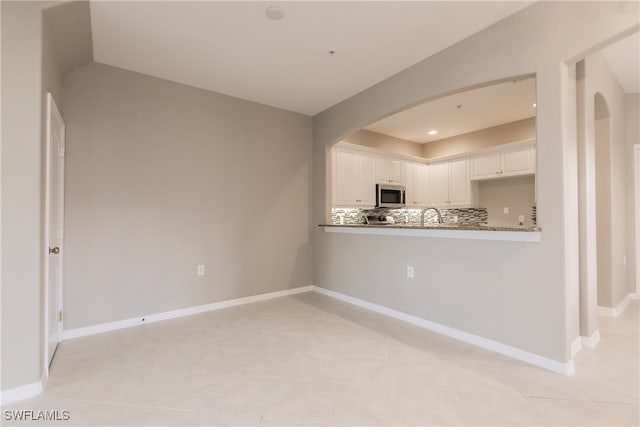 interior space featuring sink and light tile patterned flooring