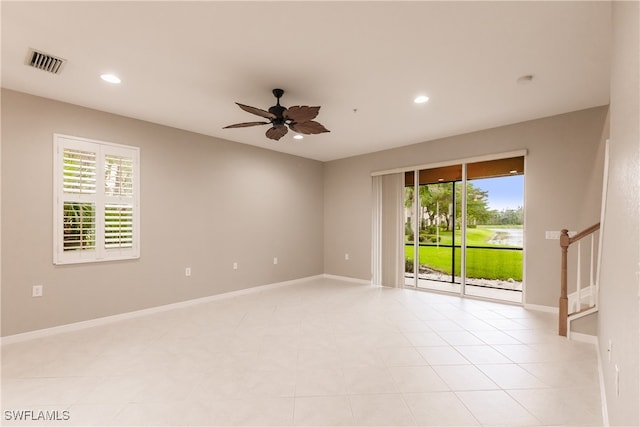 empty room with ceiling fan and a healthy amount of sunlight