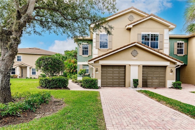 view of front of property featuring a garage and a front lawn