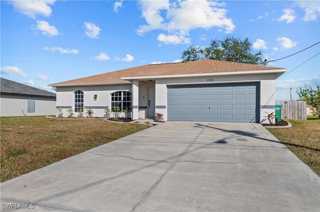 view of front of property featuring a garage and a front lawn