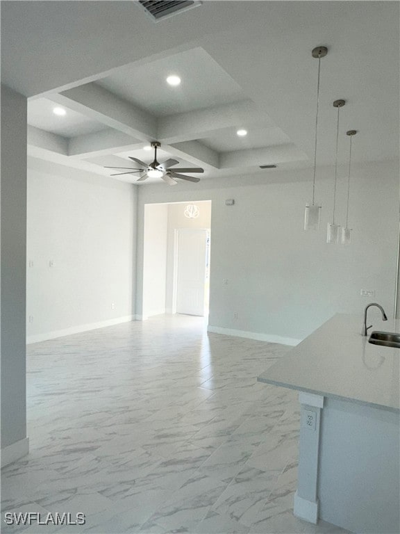 interior space featuring ceiling fan, beam ceiling, sink, and coffered ceiling