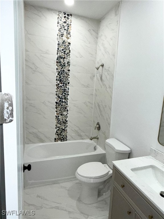 full bathroom with vanity, tiled shower / bath combo, and toilet