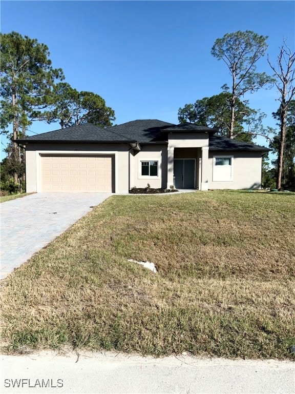 view of front of house with a front yard and a garage