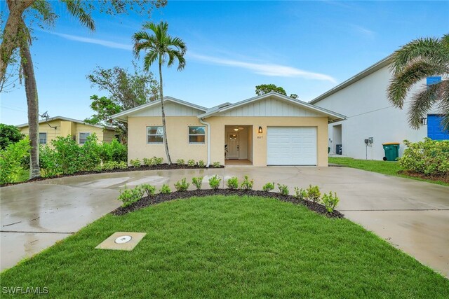 ranch-style house with a garage and a front lawn