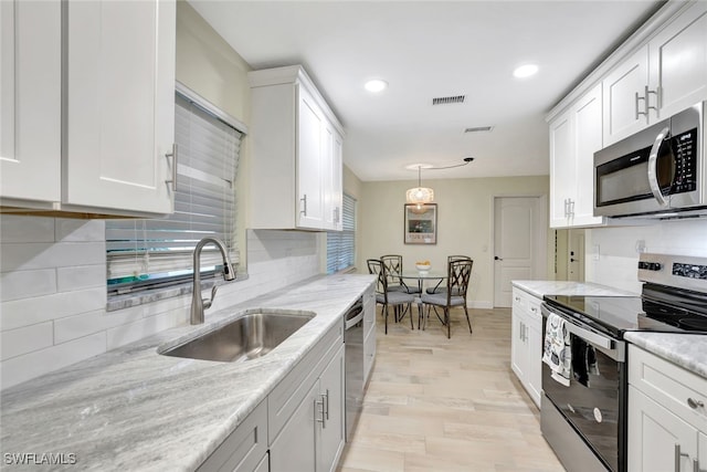 kitchen featuring white cabinetry and stainless steel appliances