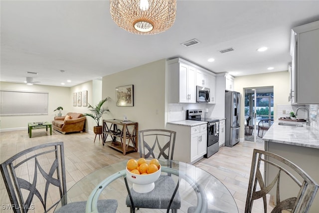 dining room featuring light hardwood / wood-style floors and sink