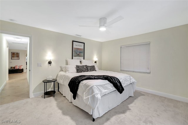 bedroom with light carpet and ceiling fan