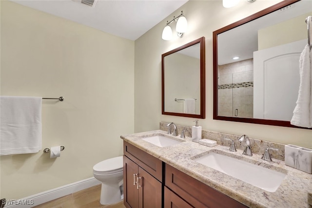 bathroom with vanity, toilet, and an enclosed shower