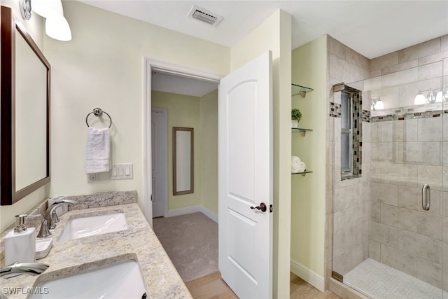 bathroom featuring vanity, wood-type flooring, and a shower with door