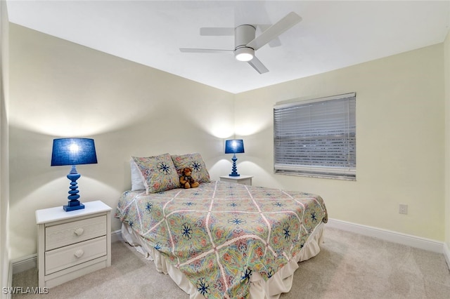 bedroom featuring light colored carpet and ceiling fan