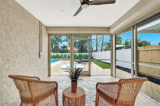 sunroom with ceiling fan