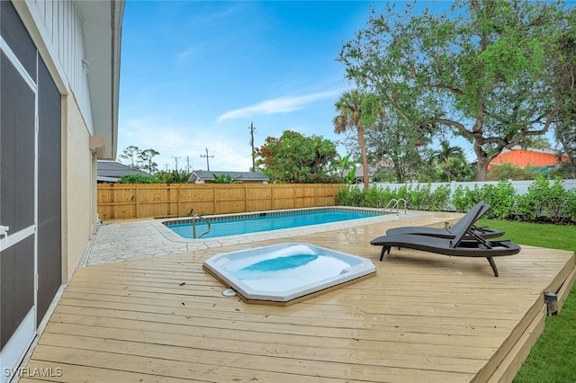 view of pool featuring a hot tub and a deck