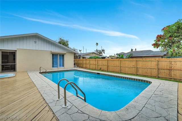 view of swimming pool featuring a deck