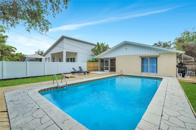 view of pool featuring a patio and a sunroom