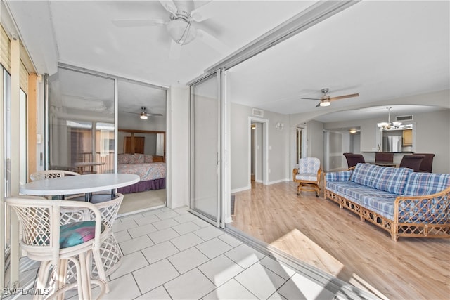 sunroom / solarium with a chandelier