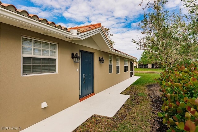4747 San Carlo Ct, Naples, FL 34109 - property entrance featuring stucco siding and a tiled roof
