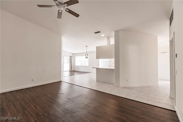 unfurnished living room with ceiling fan and light wood-type flooring