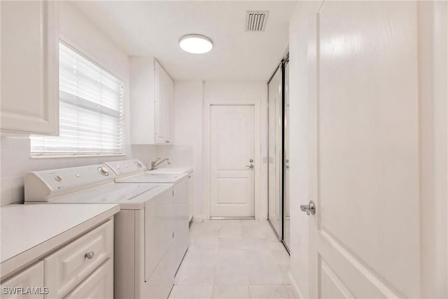 4747 San Carlo Ct, Naples, FL 34109 - washroom with cabinet space, washer and clothes dryer, and light tile patterned floors