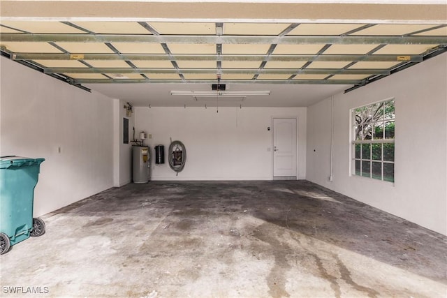 garage featuring water heater and electric panel