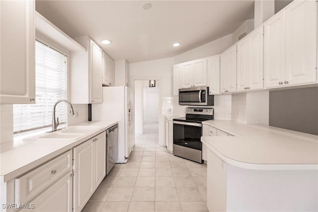 4747 San Carlo Ct, Naples, FL 34109 - kitchen featuring appliances with stainless steel finishes, a sink, light countertops, white cabinets, and recessed lighting