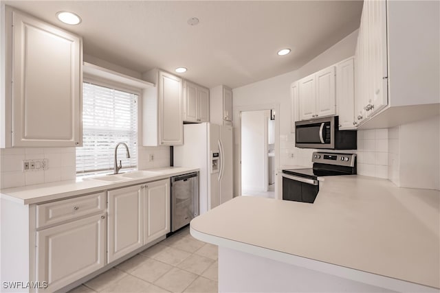 kitchen featuring sink, white cabinetry, stainless steel appliances, light tile patterned flooring, and decorative backsplash