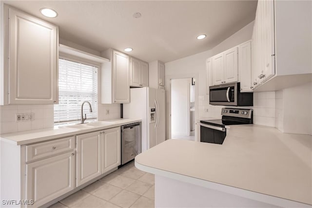 4747 San Carlo Ct, Naples, FL 34109 - kitchen with appliances with stainless steel finishes, a sink, tasteful backsplash, white cabinetry, and recessed lighting