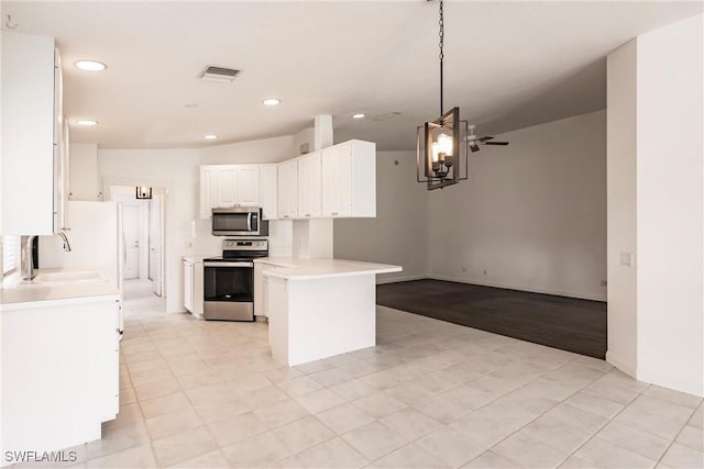 4747 San Carlo Ct, Naples, FL 34109 - kitchen with stainless steel appliances, a sink, white cabinets, recessed lighting, and light countertops
