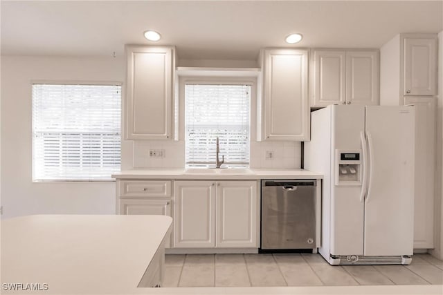 4747 San Carlo Ct, Naples, FL 34109 - kitchen with white fridge with ice dispenser, dishwasher, a sink, white cabinets, and recessed lighting