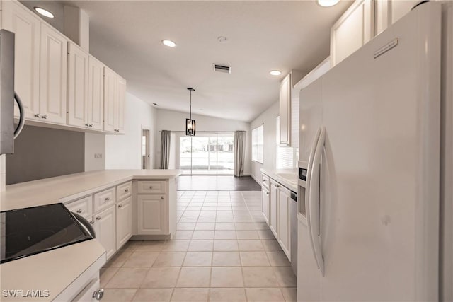 4747 San Carlo Ct, Naples, FL 34109 - kitchen featuring white fridge with ice dispenser, a peninsula, white cabinets, recessed lighting, and vaulted ceiling