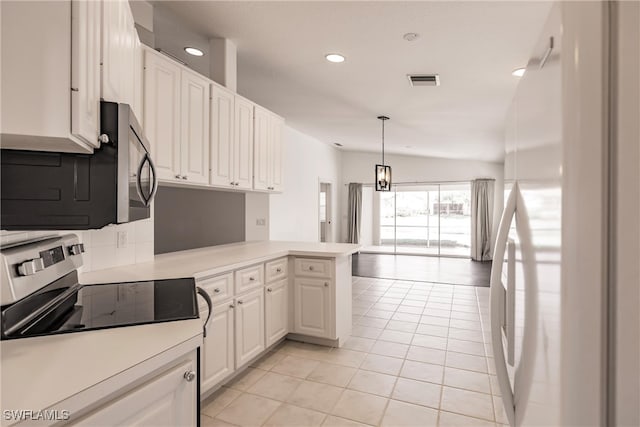 kitchen with light tile patterned flooring, pendant lighting, white cabinets, white fridge, and kitchen peninsula