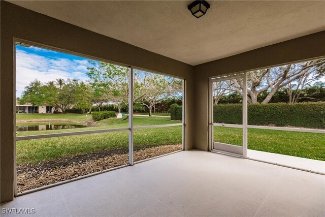 4747 San Carlo Ct, Naples, FL 34109 - unfurnished sunroom featuring a water view