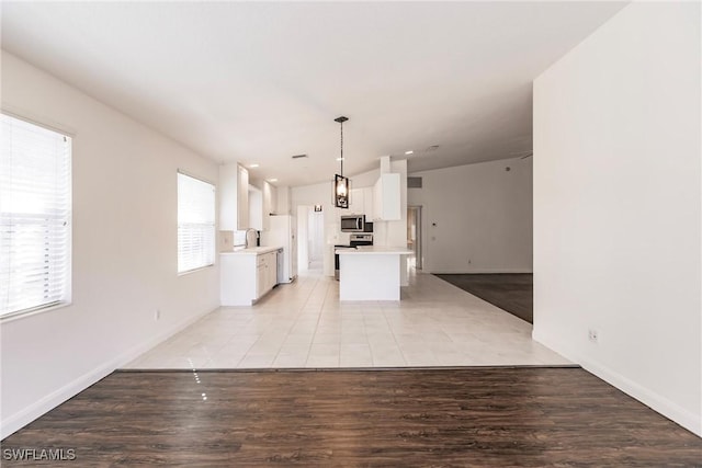 4747 San Carlo Ct, Naples, FL 34109 - unfurnished living room featuring a sink, baseboards, lofted ceiling, and light wood finished floors