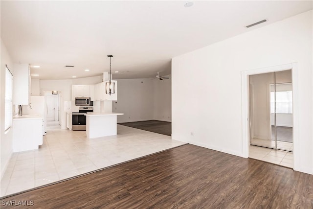 4747 San Carlo Ct, Naples, FL 34109 - unfurnished living room featuring light wood-type flooring, a ceiling fan, recessed lighting, and baseboards