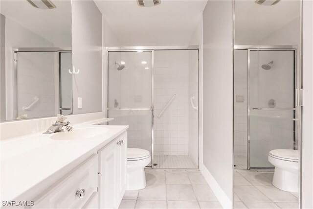 bathroom featuring a shower with shower door, tile patterned floors, and toilet