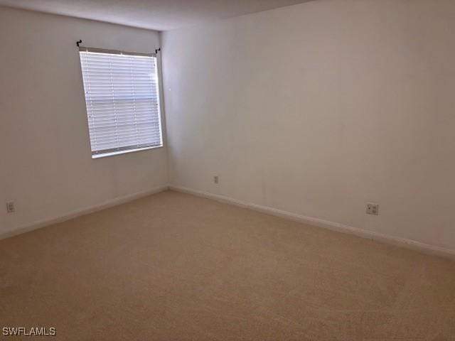 4747 San Carlo Ct, Naples, FL 34109 - spare room featuring light carpet and baseboards