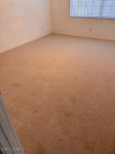 4747 San Carlo Ct, Naples, FL 34109 - carpeted spare room featuring baseboards
