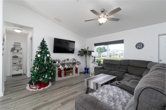 living room with wood-type flooring, vaulted ceiling, and ceiling fan