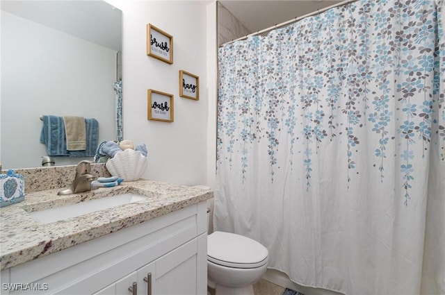 bathroom with vanity, curtained shower, and toilet