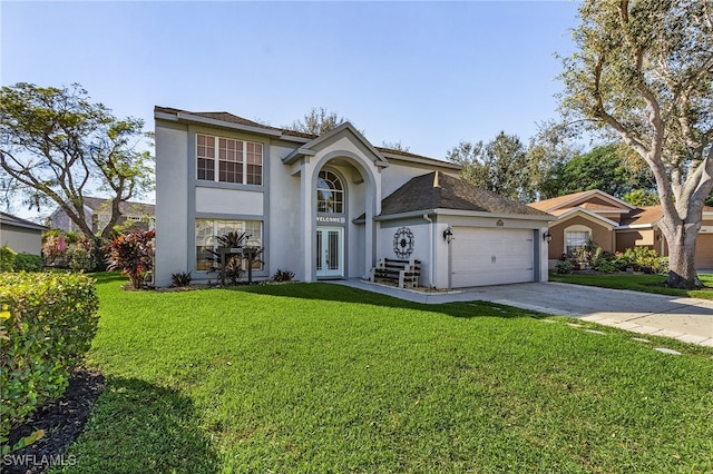 view of property featuring french doors, a front yard, and a garage