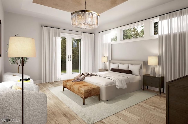 bedroom with a notable chandelier, french doors, light hardwood / wood-style flooring, and a tray ceiling