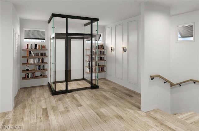 wine room with light wood-type flooring