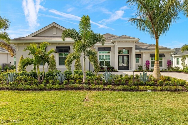 view of front of home featuring a front yard and french doors