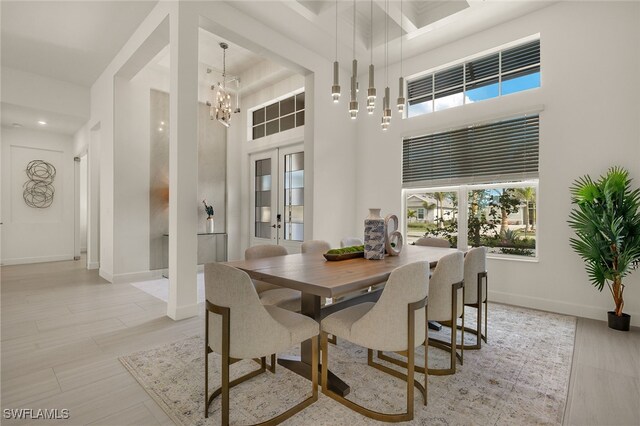 dining room with a high ceiling and an inviting chandelier